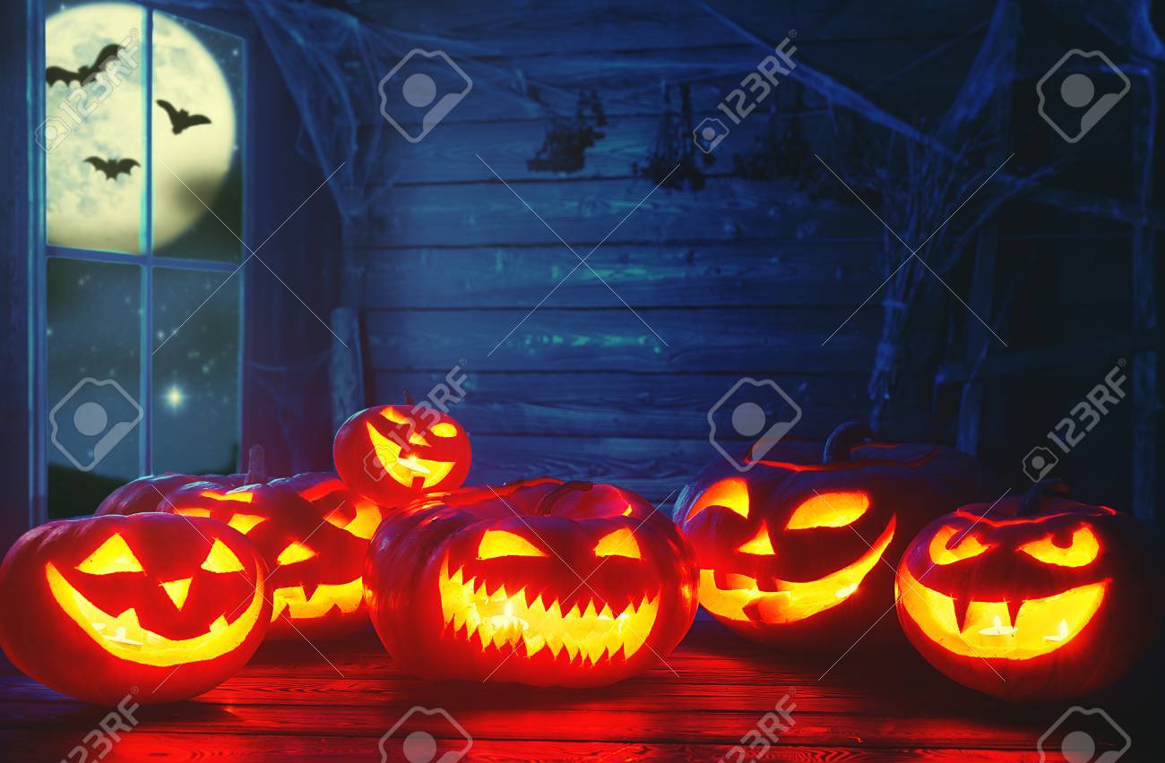 Spooky Halloween Background. Scary Pumpkin With Burning Eyes And Smiles In  The Night Stock Photo, Picture and Royalty Free Image. Image 63076991., image size:1300x852
