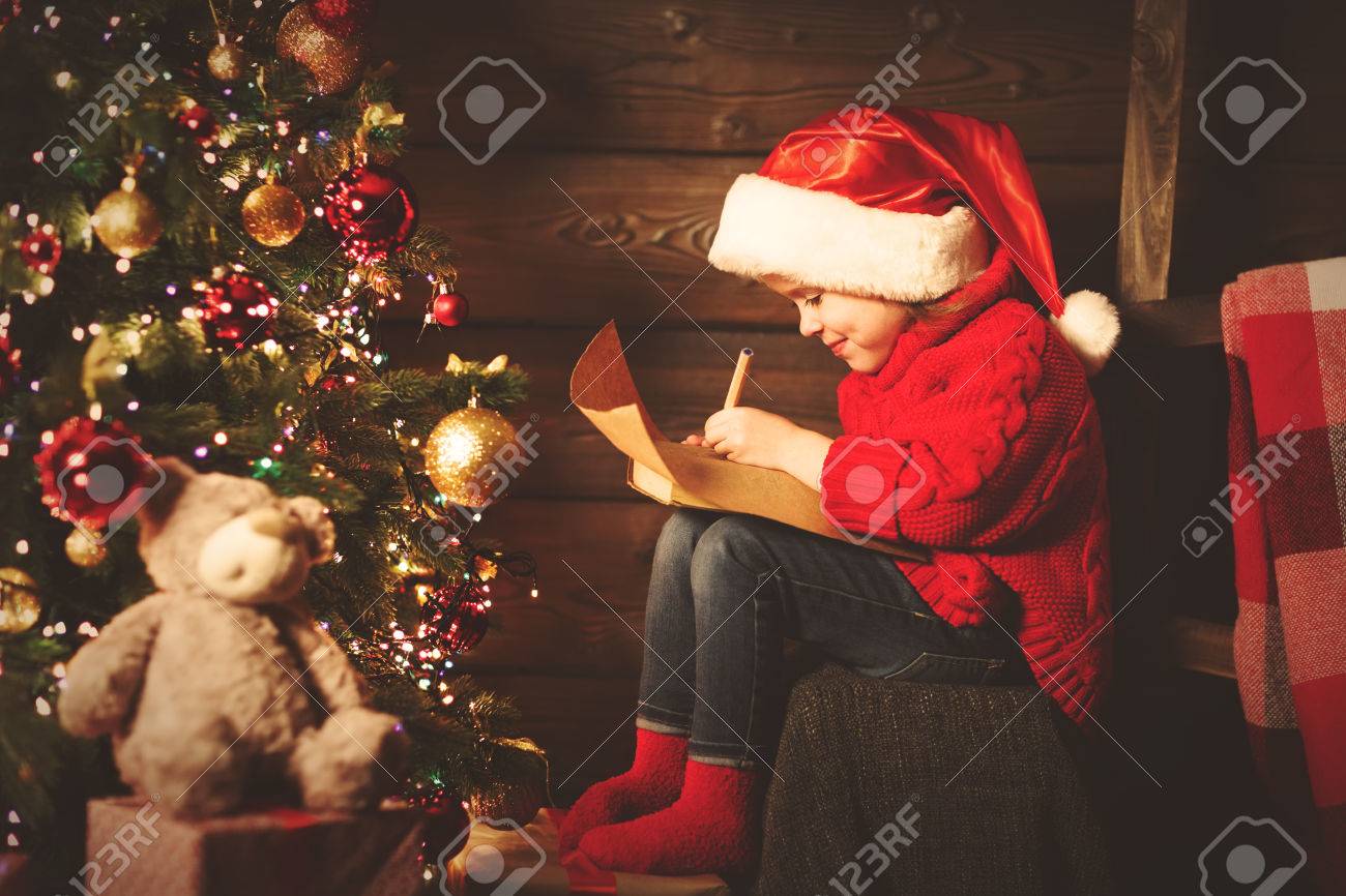 Happy Child Girl Writes Letter To Santa Claus At The Christmas