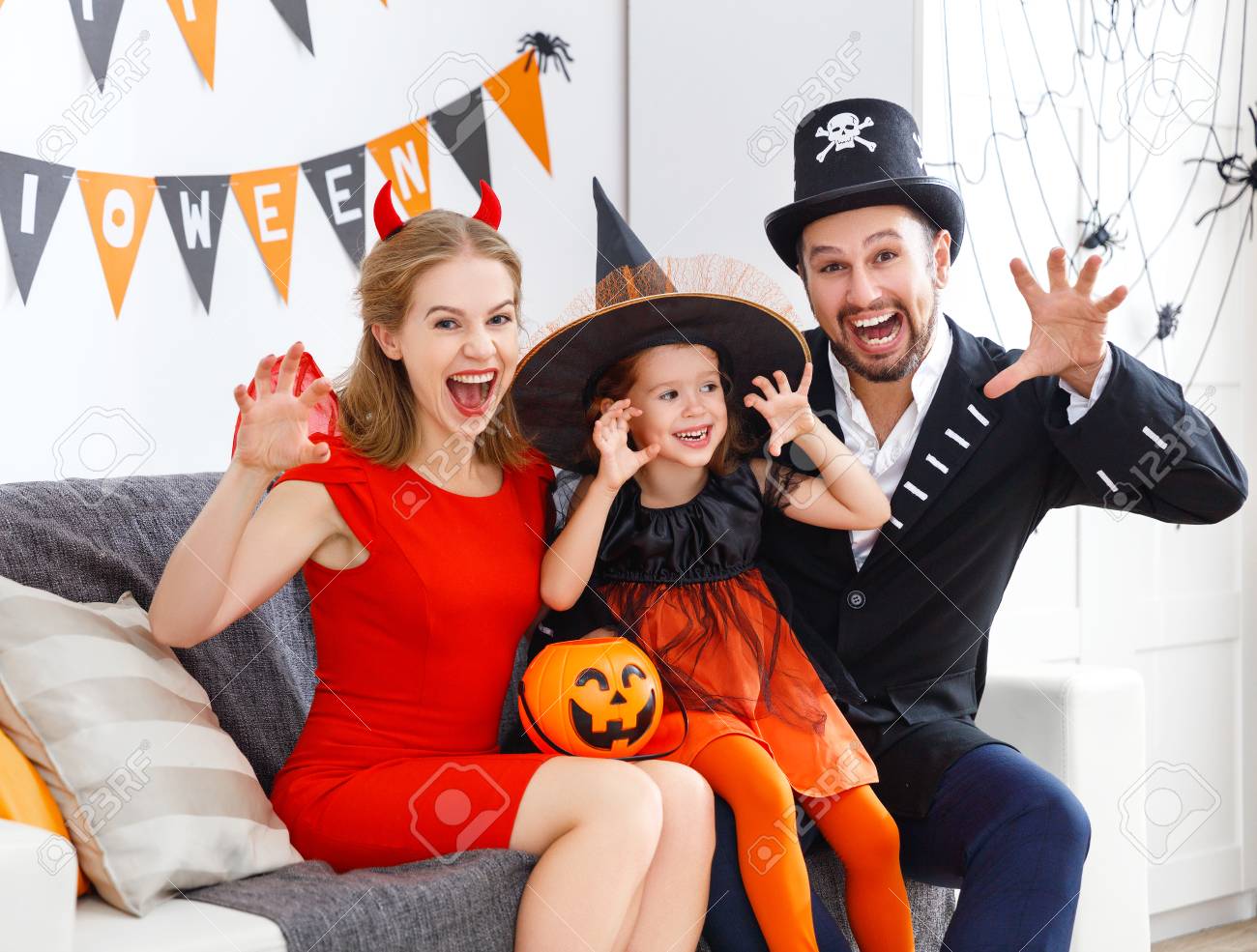 happy family in costumes getting ready for halloween at home - 86199812 happy family in costumes getting ready for halloween at home - 86199812