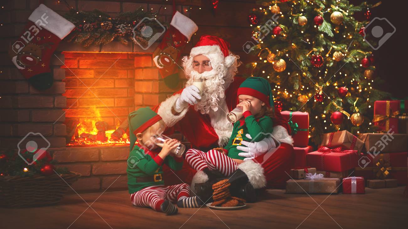The Christmas Santa Claus With Elves Drink Milk And Eat Cookies Stock Photo Picture And Royalty Free Image Image 89486592