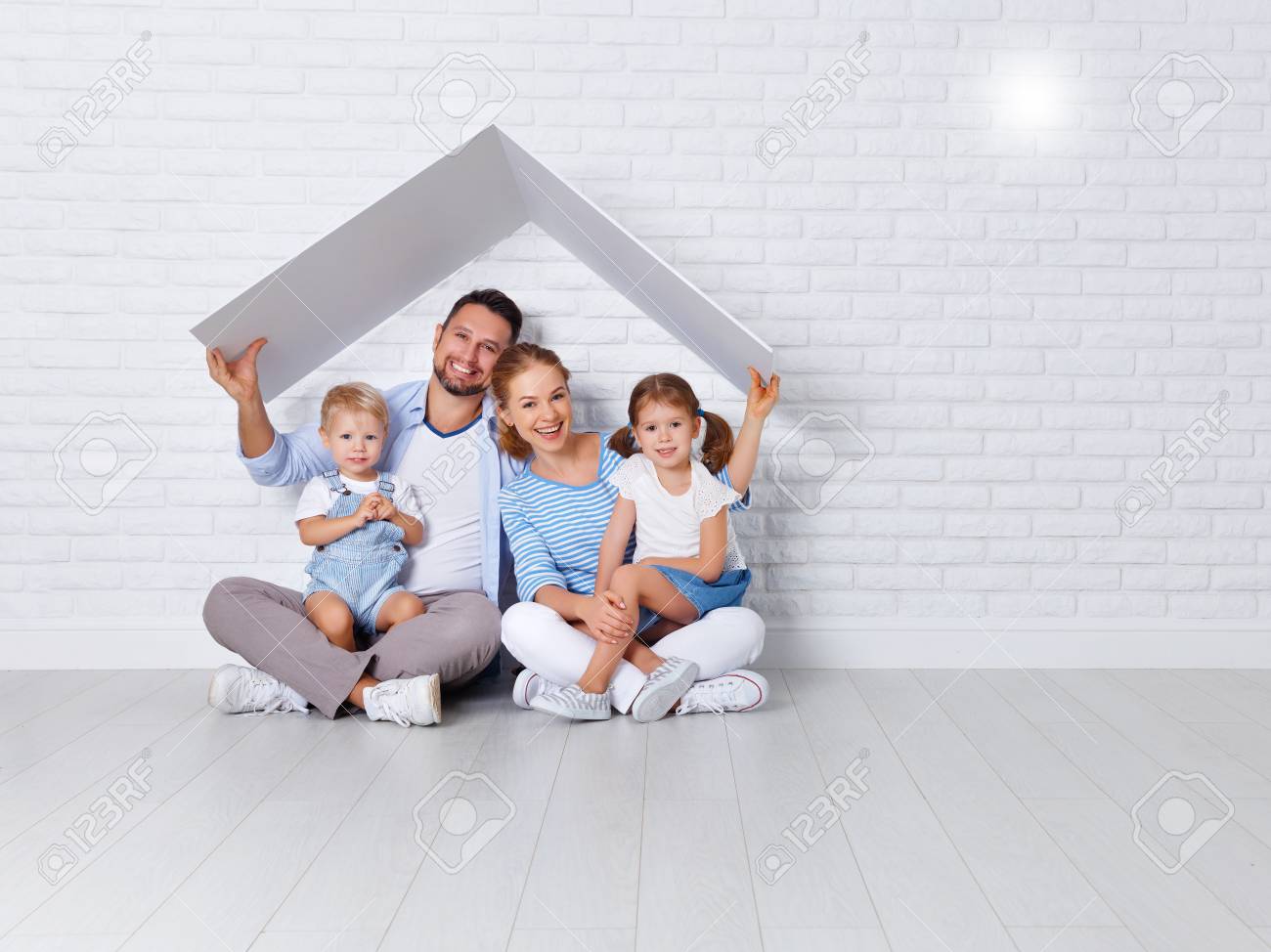 concept housing a young family. mother father and children in a new home - 94301045 concept housing a young family. mother father and children in a new home - 94301045