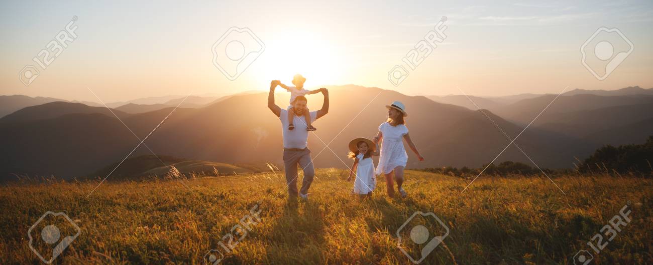 Happy family: mother, father, children son and daughter on nature on sunset - 105557338 Happy family: mother, father, children son and daughter on nature on sunset - 105557338