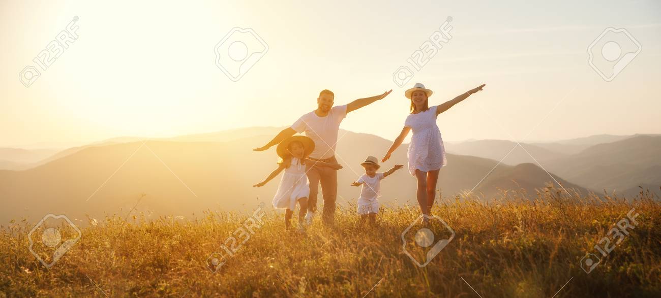 Happy family: mother, father, children son and daughter on nature on sunset - 105557354 Happy family: mother, father, children son and daughter on nature on sunset - 105557354