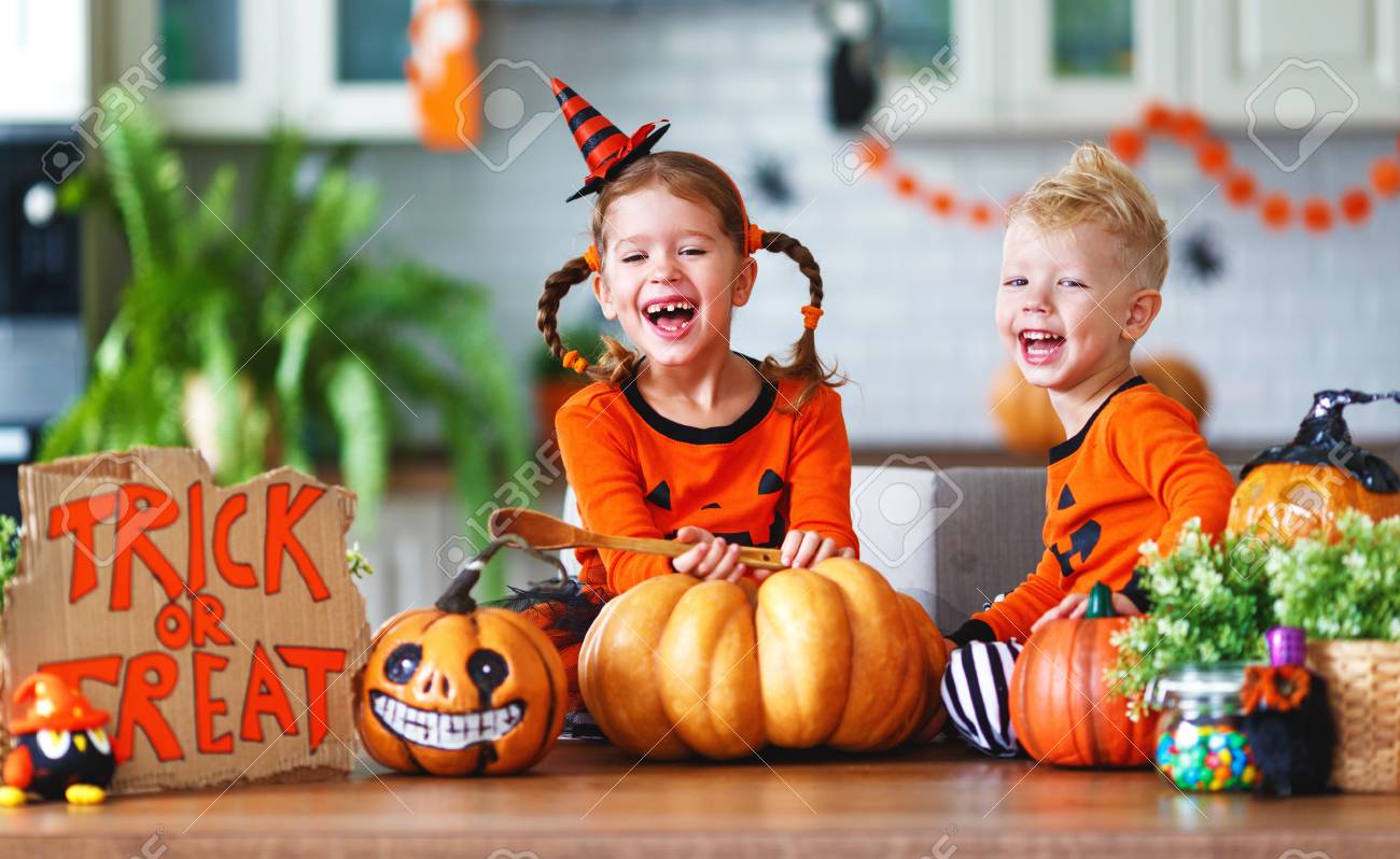 happy children in costumes of pumpkins are preparing the home for holiday Halloween - 108162296 happy children in costumes of pumpkins are preparing the home for holiday Halloween - 108162296