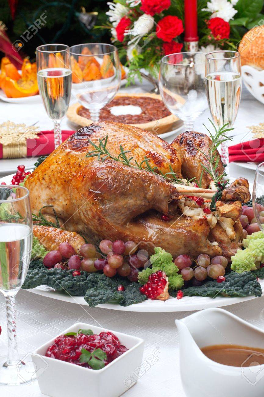 Holiday-decorated table, Christmas tree, champagne, and roasted turkey - 20705194 Holiday-decorated table, Christmas tree, champagne, and roasted turkey - 20705194