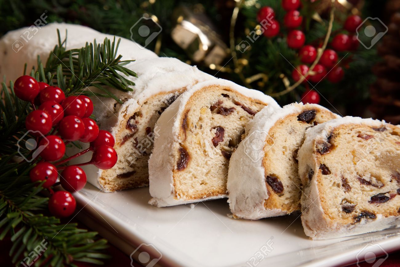 Traditional German Christmas cake - Cranberry Stollen, Christmas tree, ornaments, and candles - 22659323 Traditional German Christmas cake - Cranberry Stollen, Christmas tree, ornaments, and candles - 22659323