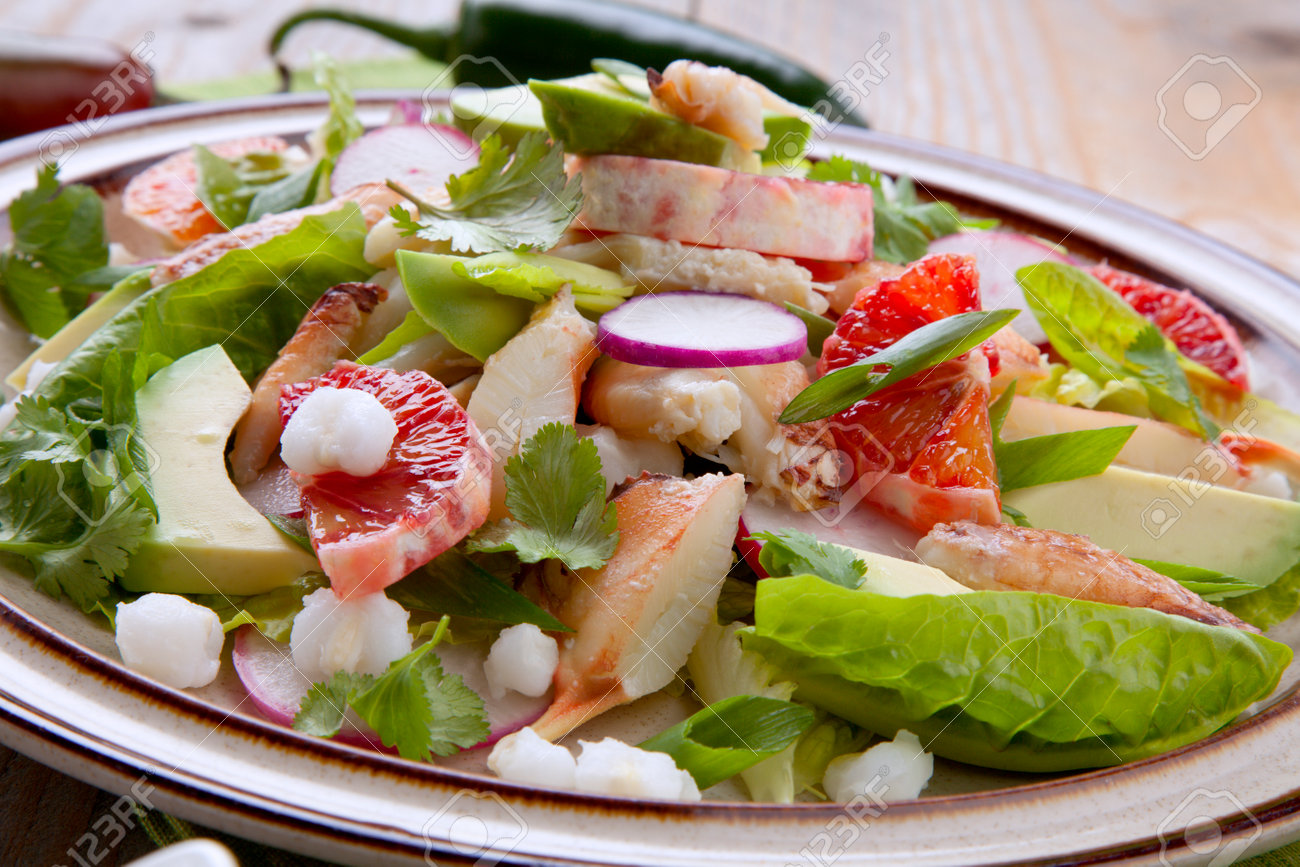 Fusion of Mexican cuisine and a traditional seafood crab salad. Closeup of Blood Orange Crab Posole Salad with fresh cooked Dungeness crab meat, avocado, radish, Romaine lettuce, and white hominy. - 162557484 Fusion of Mexican cuisine and a traditional seafood crab salad. Closeup of Blood Orange Crab Posole Salad with fresh cooked Dungeness crab meat, avocado, radish, Romaine lettuce, and white hominy. - 162557484