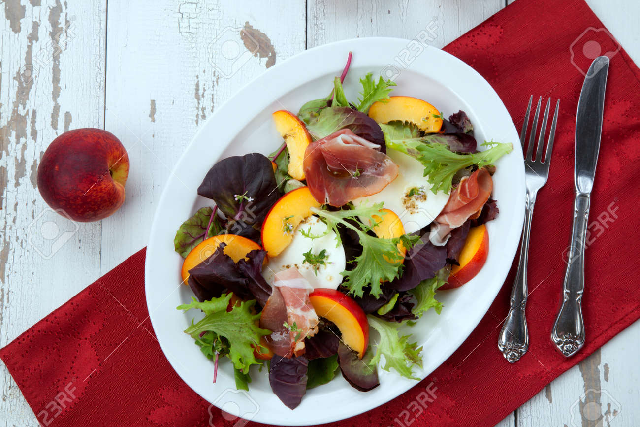 Closeup of Prosciutto peach salad with rresh Mozzarella plate mixed with spring greens. Freash peaches. - 172126134 Closeup of Prosciutto peach salad with rresh Mozzarella plate mixed with spring greens. Freash peaches. - 172126134