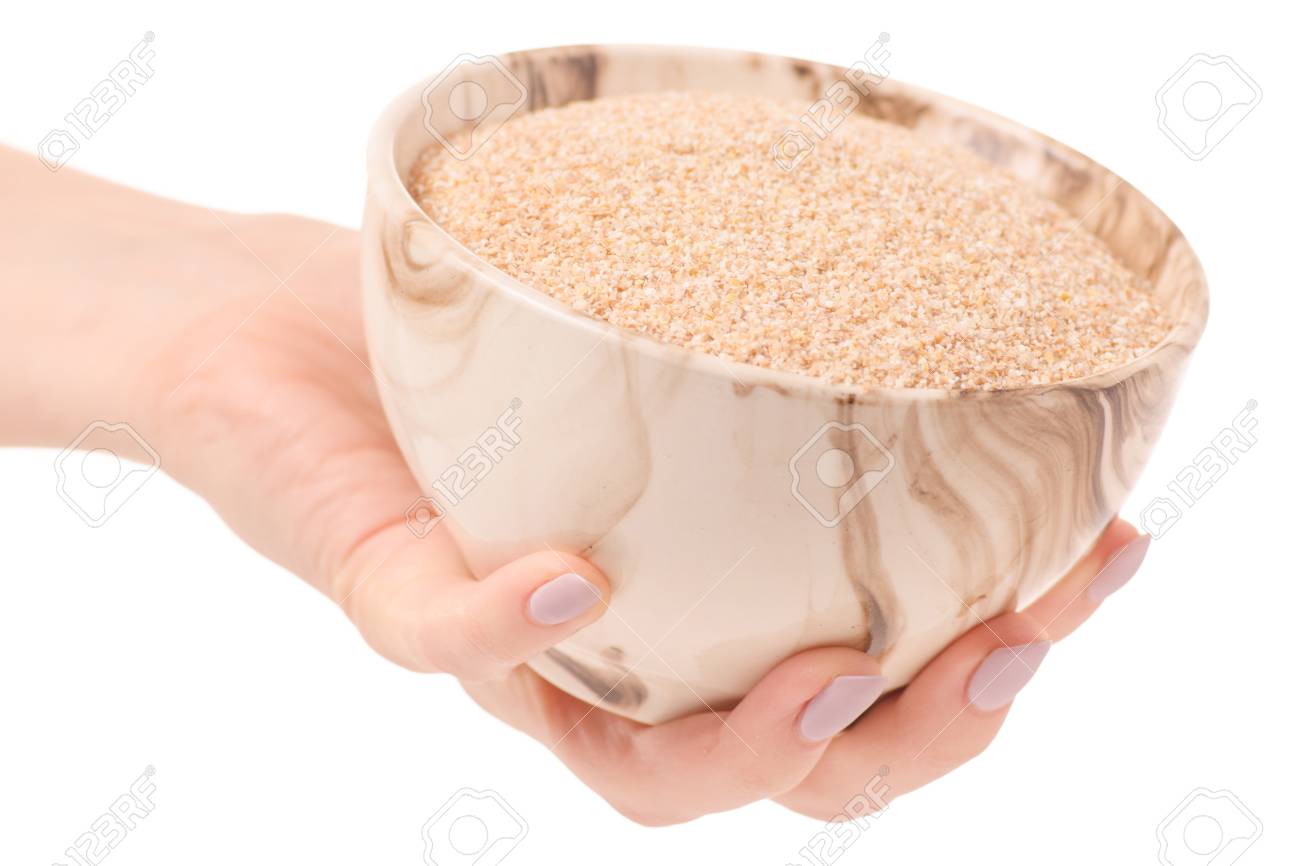 91908262-wheat-porridge-millet-hand-on-w