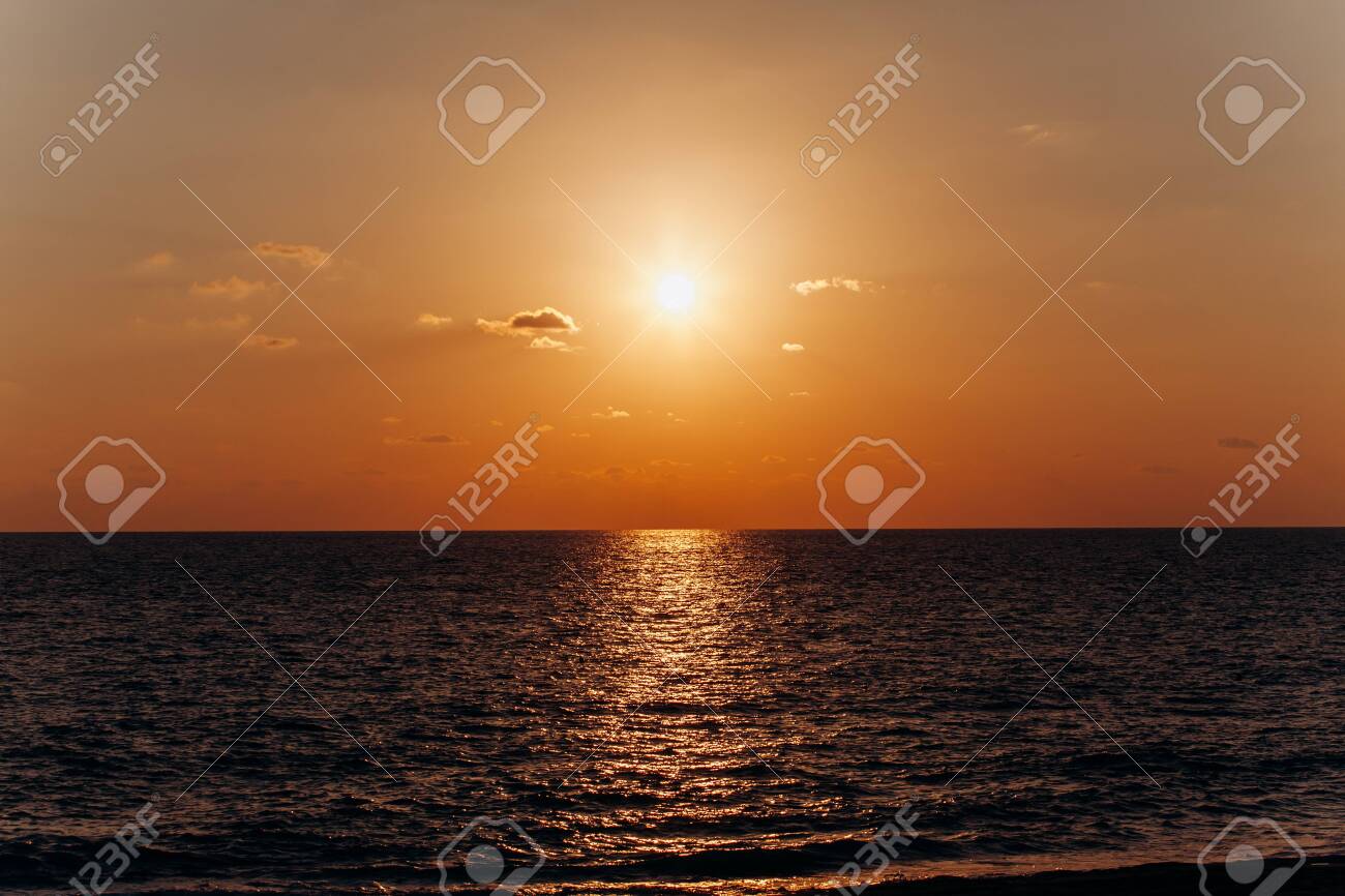Beautiful sunset above the sea. Reflection of sunset in the water. - 137184430 Beautiful sunset above the sea. Reflection of sunset in the water. - 137184430