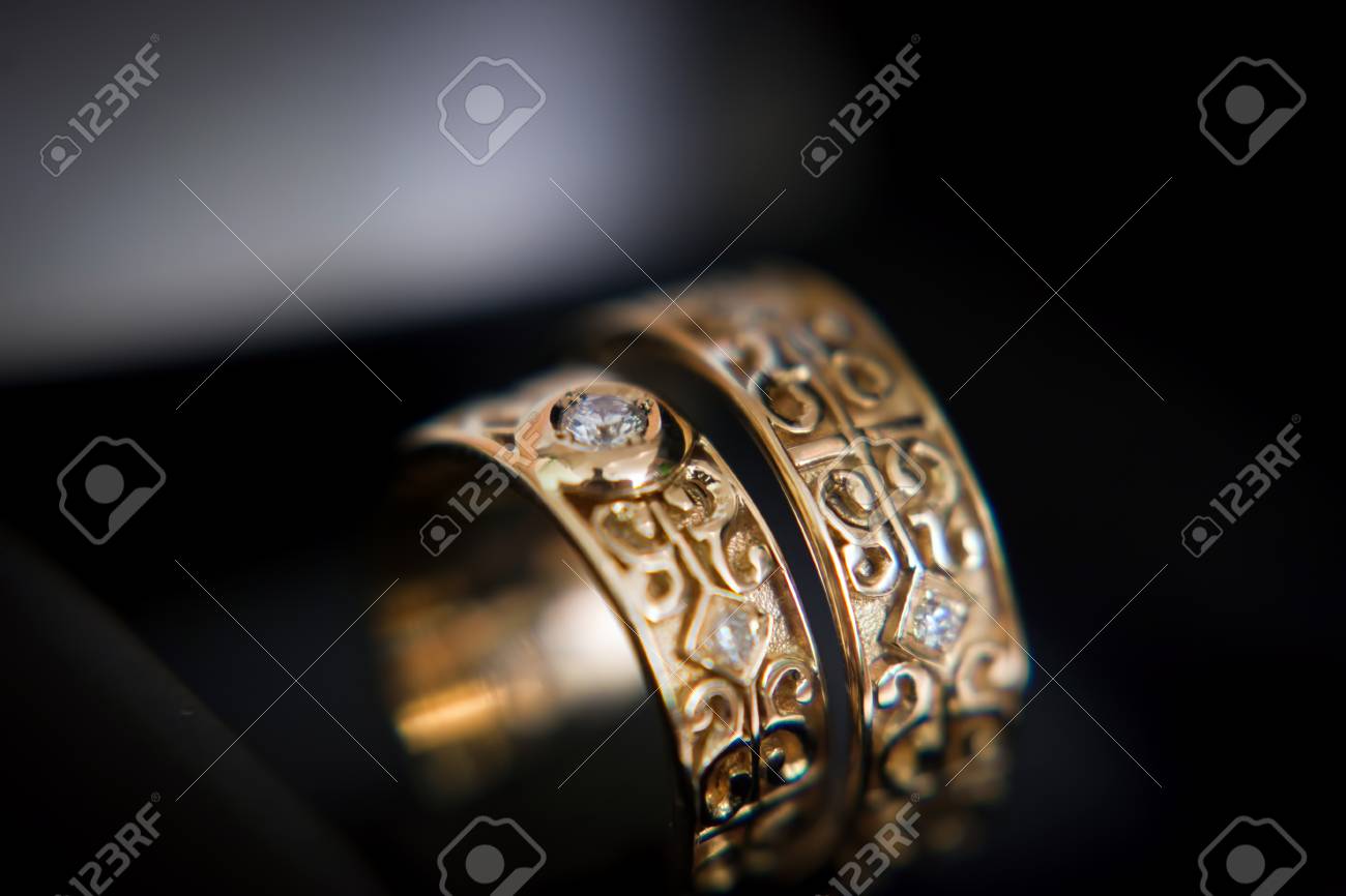 carved wedding rings with jewels, closeup - 113768190 carved wedding rings with jewels, closeup - 113768190