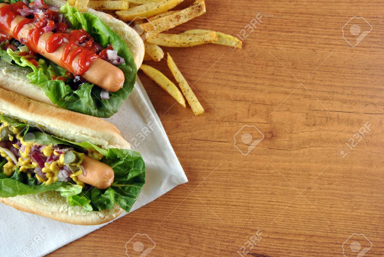 two hot dogs with salad, onions and sauce - 24621315 two hot dogs with salad, onions and sauce - 24621315