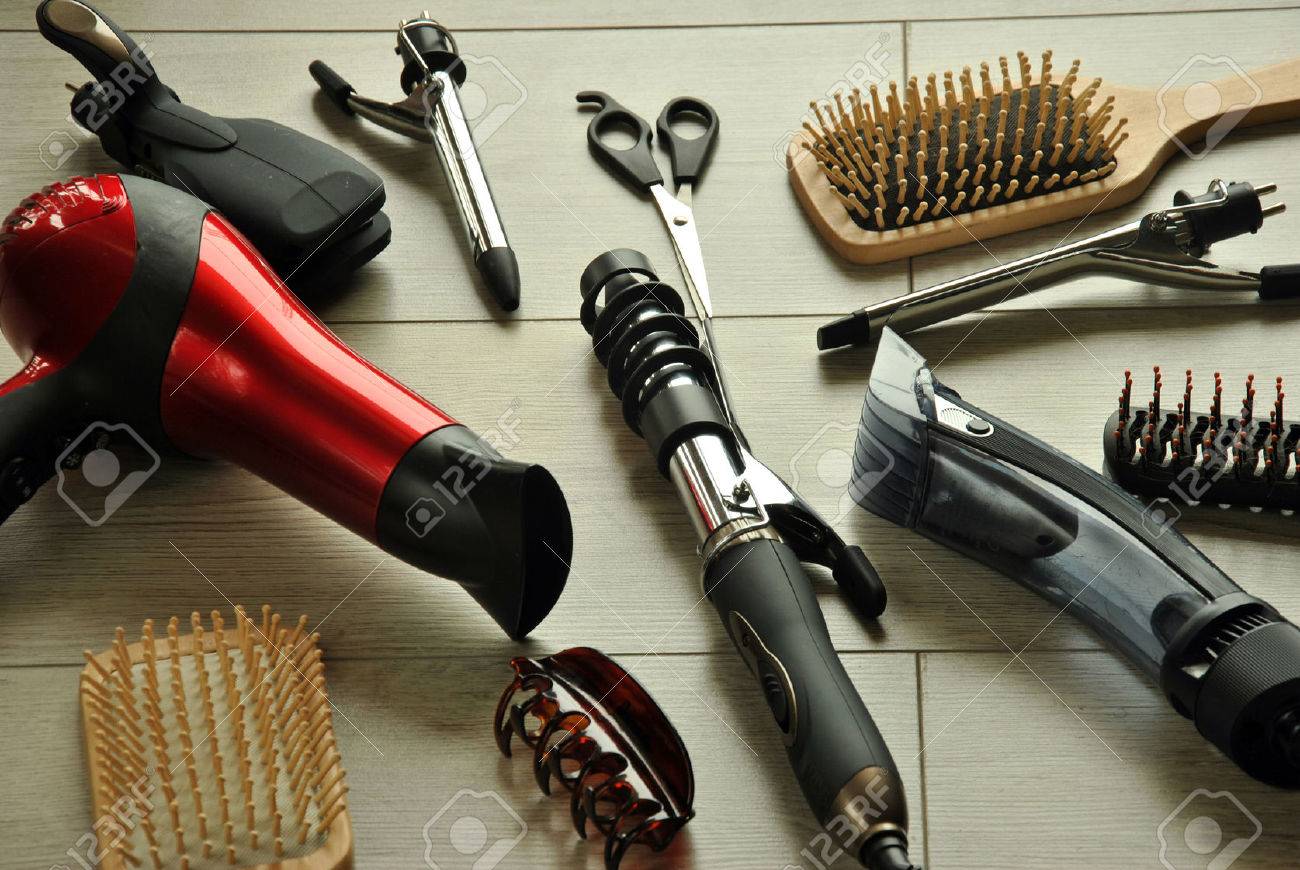hairdressing tools like dryers, scissors and combs on a wooden floor - 38174926 hairdressing tools like dryers, scissors and combs on a wooden floor - 38174926