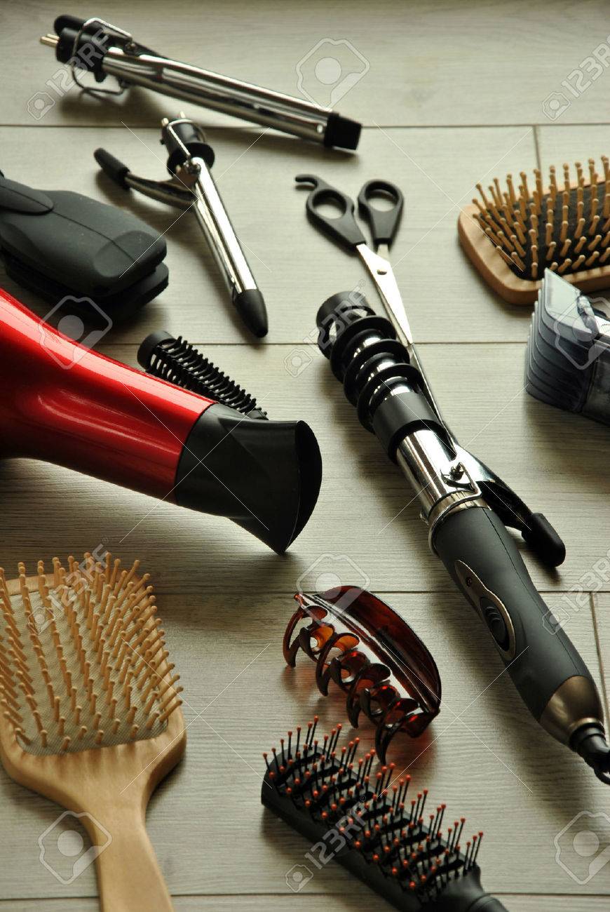 hairdressing tools like dryers, scissors and combs on a wooden floor - 38174927 hairdressing tools like dryers, scissors and combs on a wooden floor - 38174927