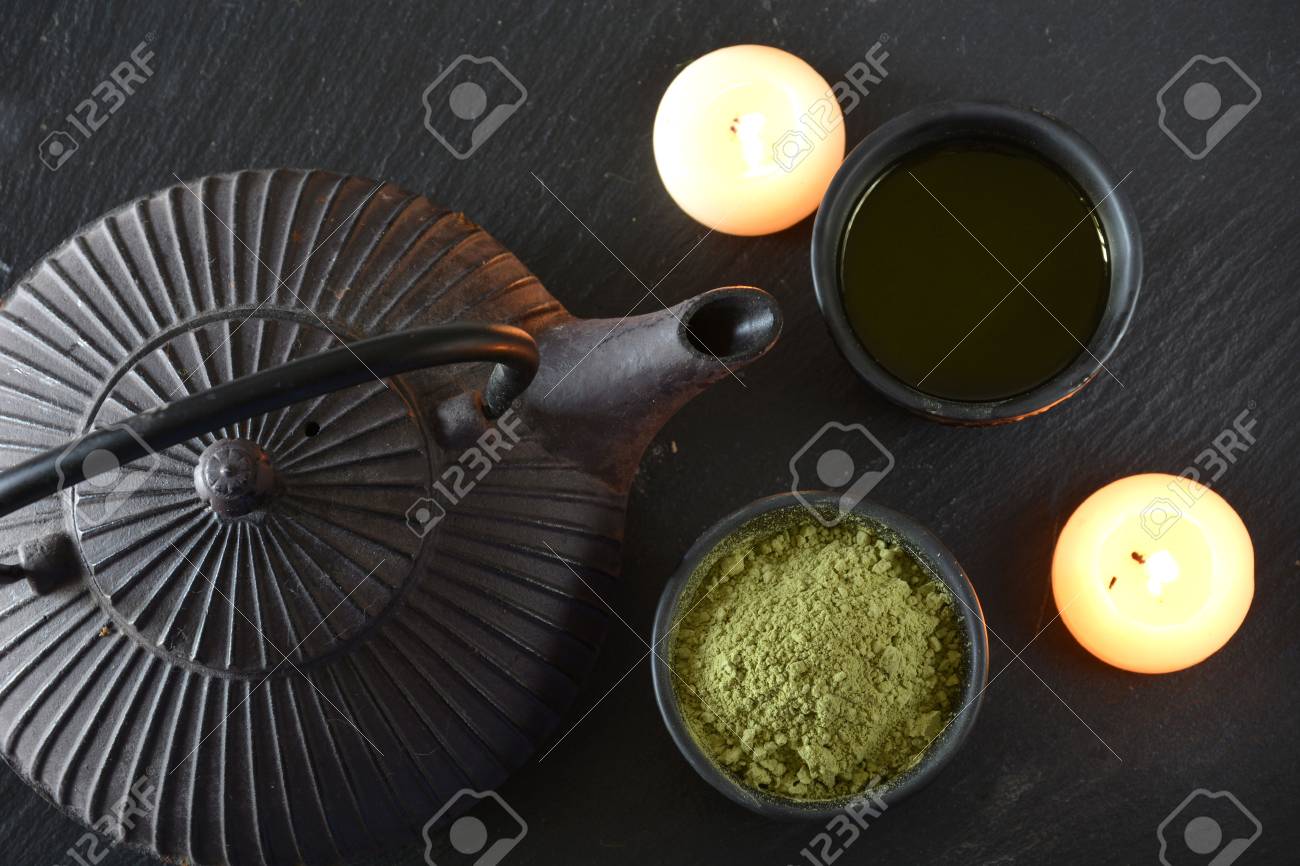 cups filled with Japanese tea kettle of hot water and incense and candles - 49850082 cups filled with Japanese tea kettle of hot water and incense and candles - 49850082