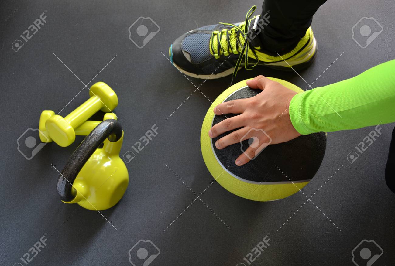 man training with kettlebell and medicine ball at home - 52911076 man training with kettlebell and medicine ball at home - 52911076