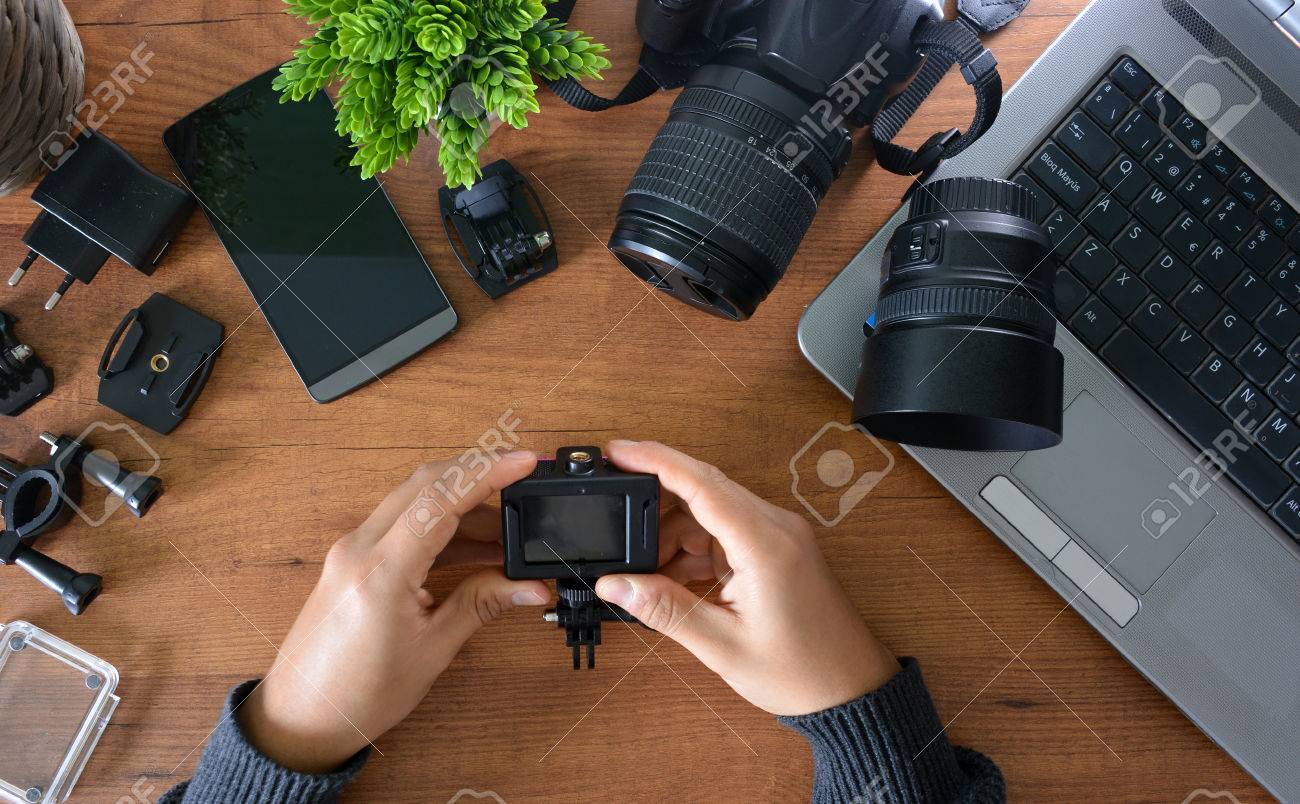 Camera's action with their accessories accompanied of a notebook and a camera reflex - 66224882 Camera's action with their accessories accompanied of a notebook and a camera reflex - 66224882