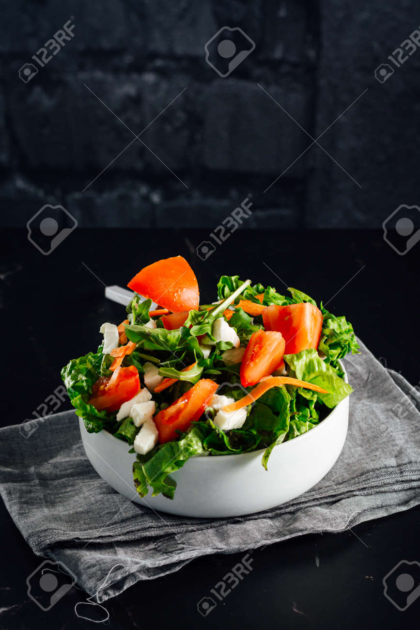 Mixed salad bowl with lettuce, tomato, arugula and mozzarella cheese. (Concept of healthy and organic food) - 165273830 Mixed salad bowl with lettuce, tomato, arugula and mozzarella cheese. (Concept of healthy and organic food) - 165273830