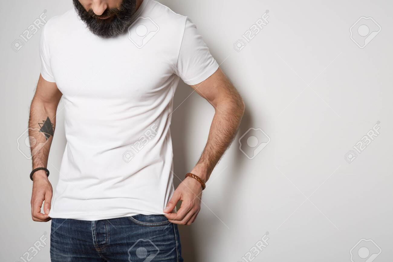 Download Attractive Brutal Tattooed Bearded Guy Poses In Blue Jeans And Stock Photo Picture And Royalty Free Image Image 121513818
