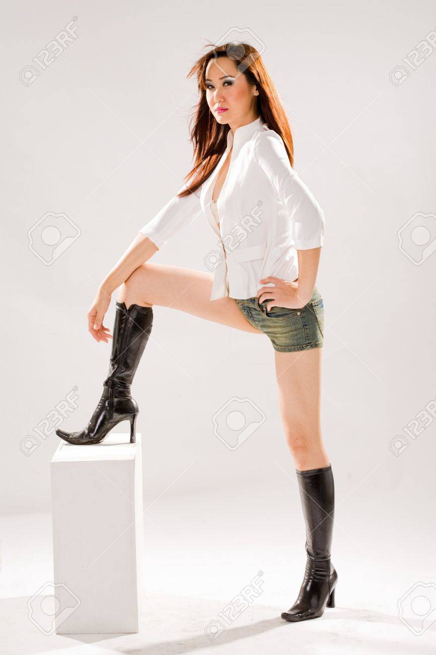 a very sexy bold woman in tight denim shorts and high boots stock very bold image