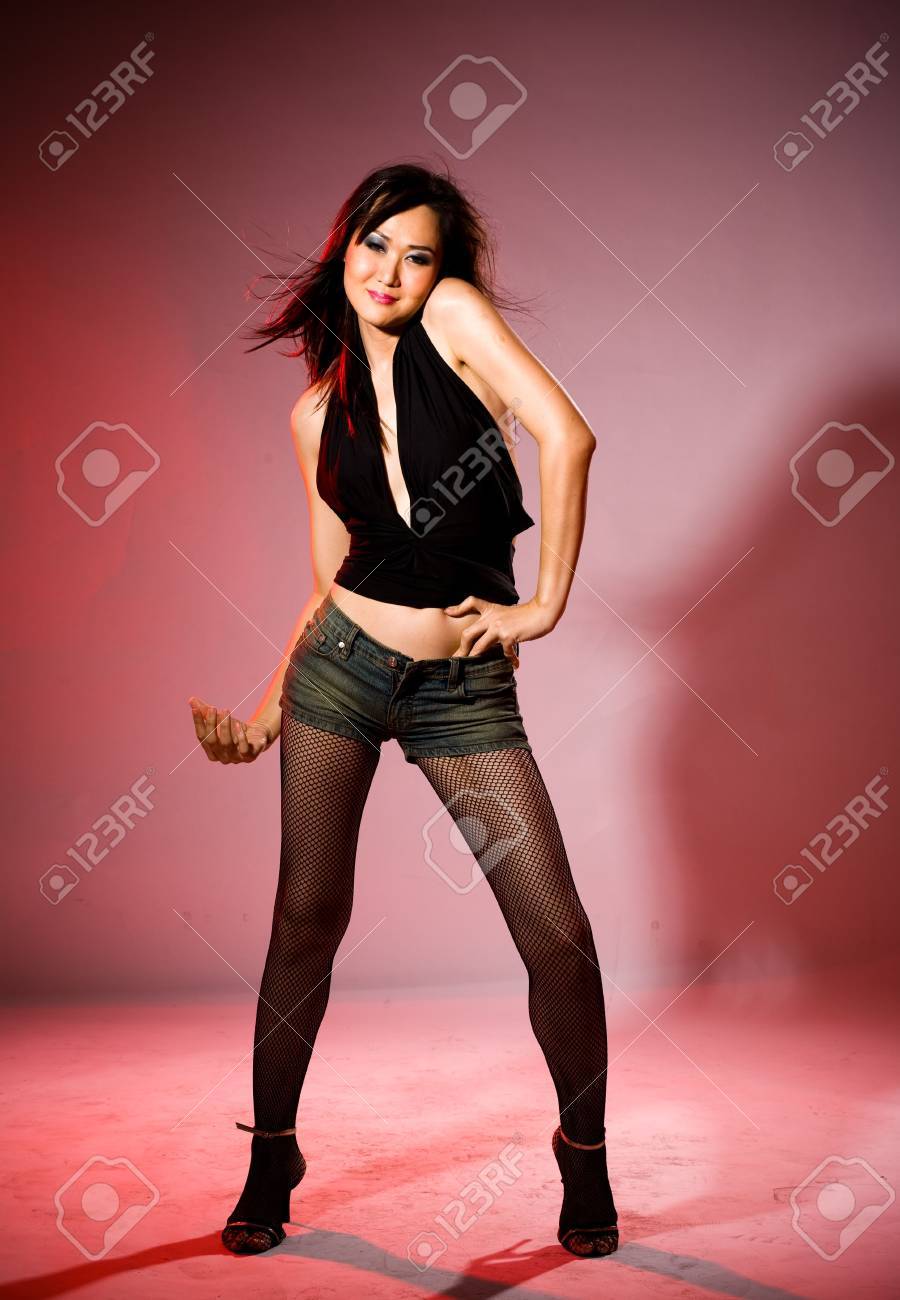 a very sexy bold woman in tight denim shorts and high boots on very bold image