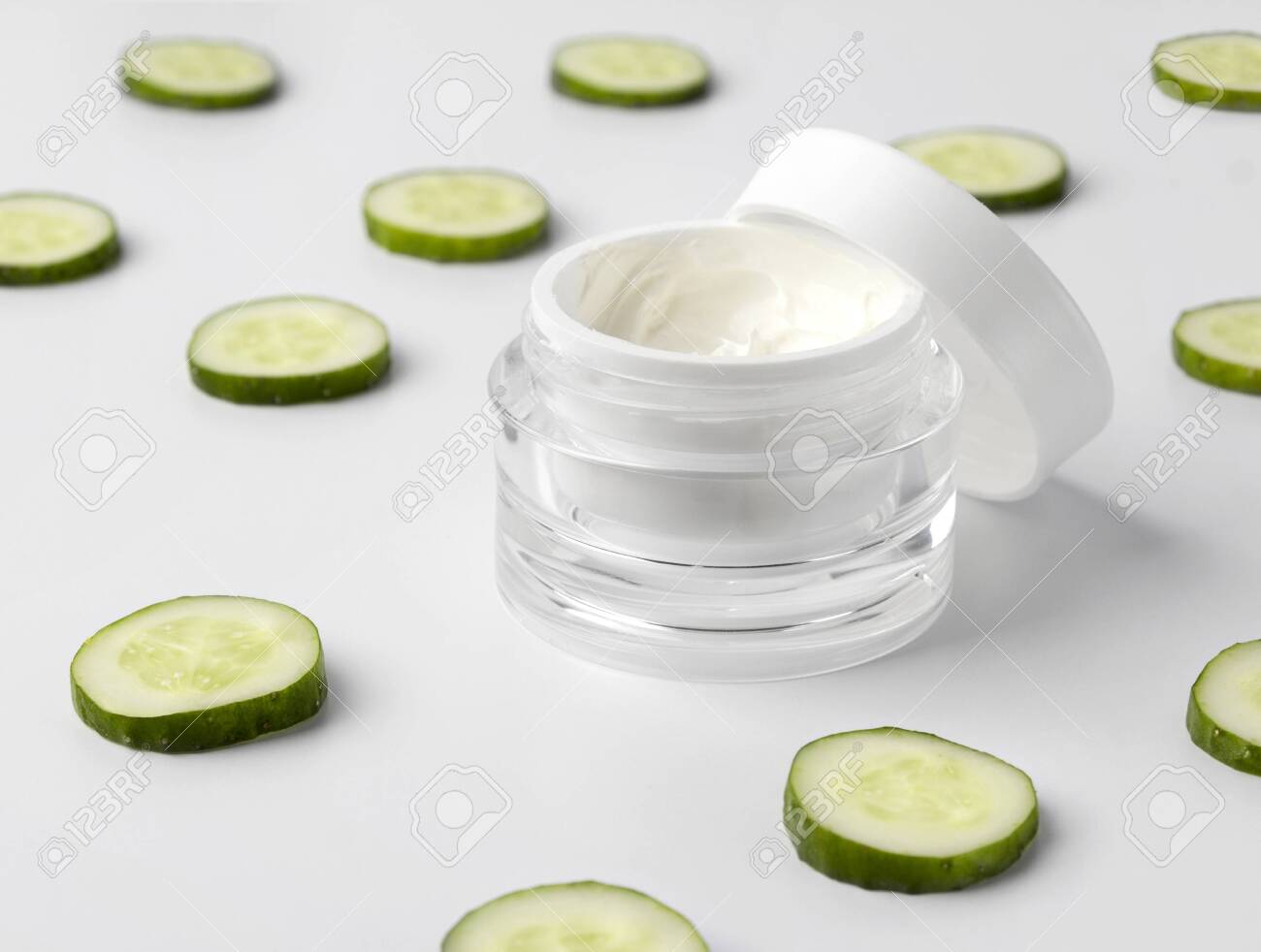 Download Opened Jar Of Cosmetic Cream With Cucumber On White Background Stock Photo Picture And Royalty Free Image Image 127424537 PSD Mockup Templates
