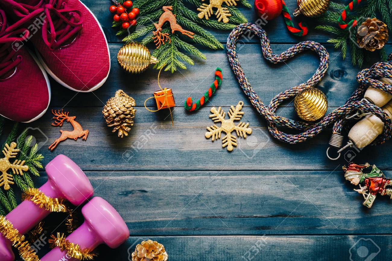 Fitness, healthy and active lifestyles love concept, dumbbells, sport shoes, skipping rope or jump rope in heart shape with Christmas decoration items on wood background. Exercise, Fitness and Working Out Merry Christmas and Happy new year concept. - 88284917 Fitness, healthy and active lifestyles love concept, dumbbells, sport shoes, skipping rope or jump rope in heart shape with Christmas decoration items on wood background. Exercise, Fitness and Working Out Merry Christmas and Happy new year concept. - 88284917