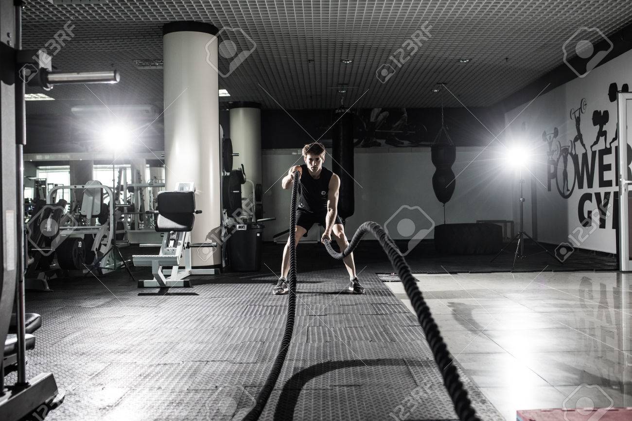 men with battle rope battle ropes exercise in the fitness gymmen with battle rope battle ropes exercise in the fitness gym crossfit stock photo