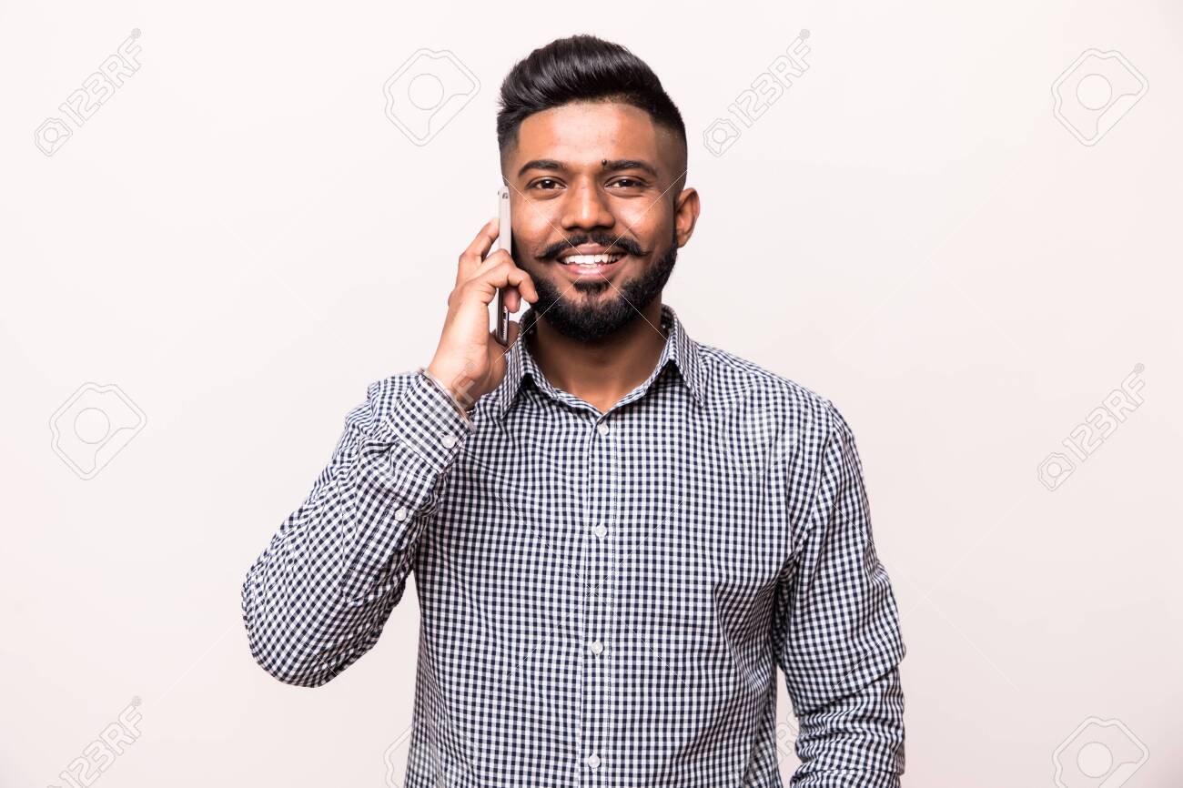 Young Happy Indian Man Talking On Mobile Phone Isolated Against White Background Stock Photo Picture And Royalty Free Image Image 126549635