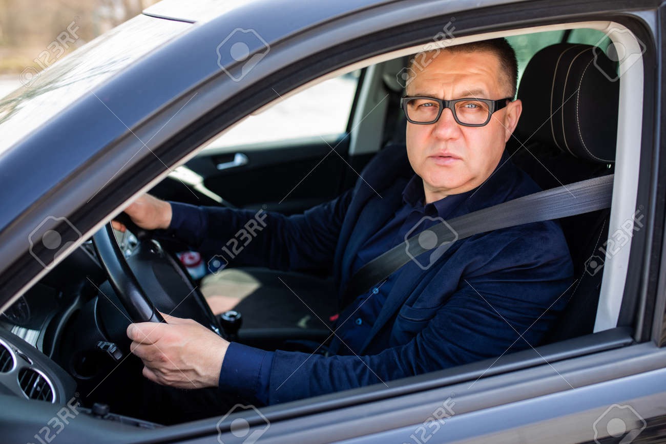 Handsome middle age man driving a car - 168811236 Handsome middle age man driving a car - 168811236