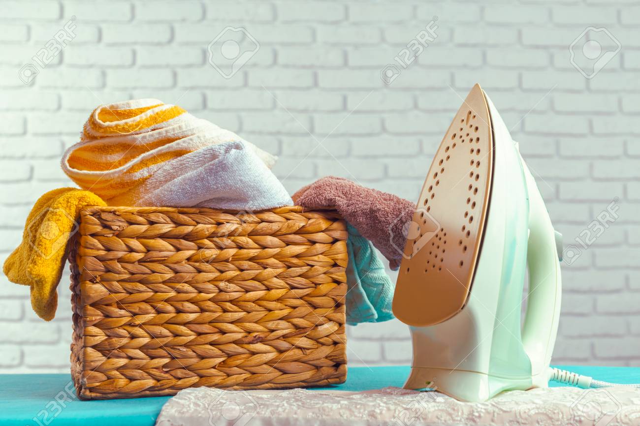Iron on ironing board on light home interior background - 77298979 Iron on ironing board on light home interior background - 77298979