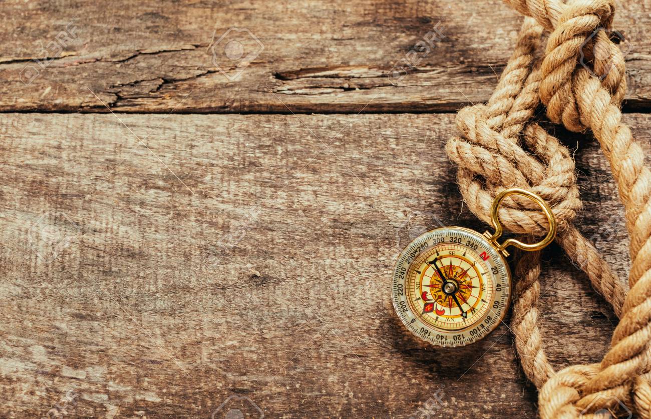 ship ropes and compass on wooden background - 77845988 ship ropes and compass on wooden background - 77845988
