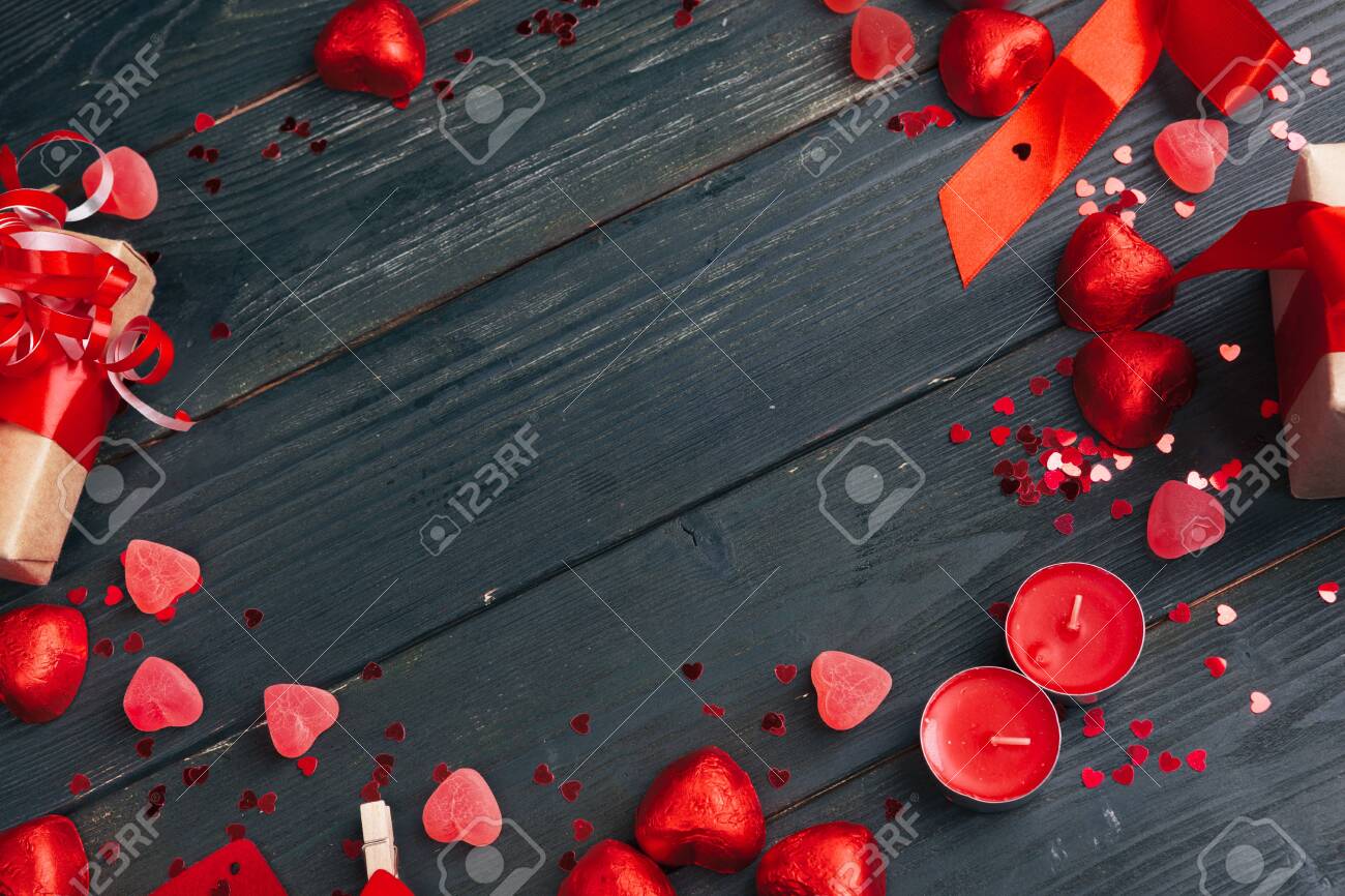 Gift box with red hearts on wooden table. creative photo. - 141378574 Gift box with red hearts on wooden table. creative photo. - 141378574