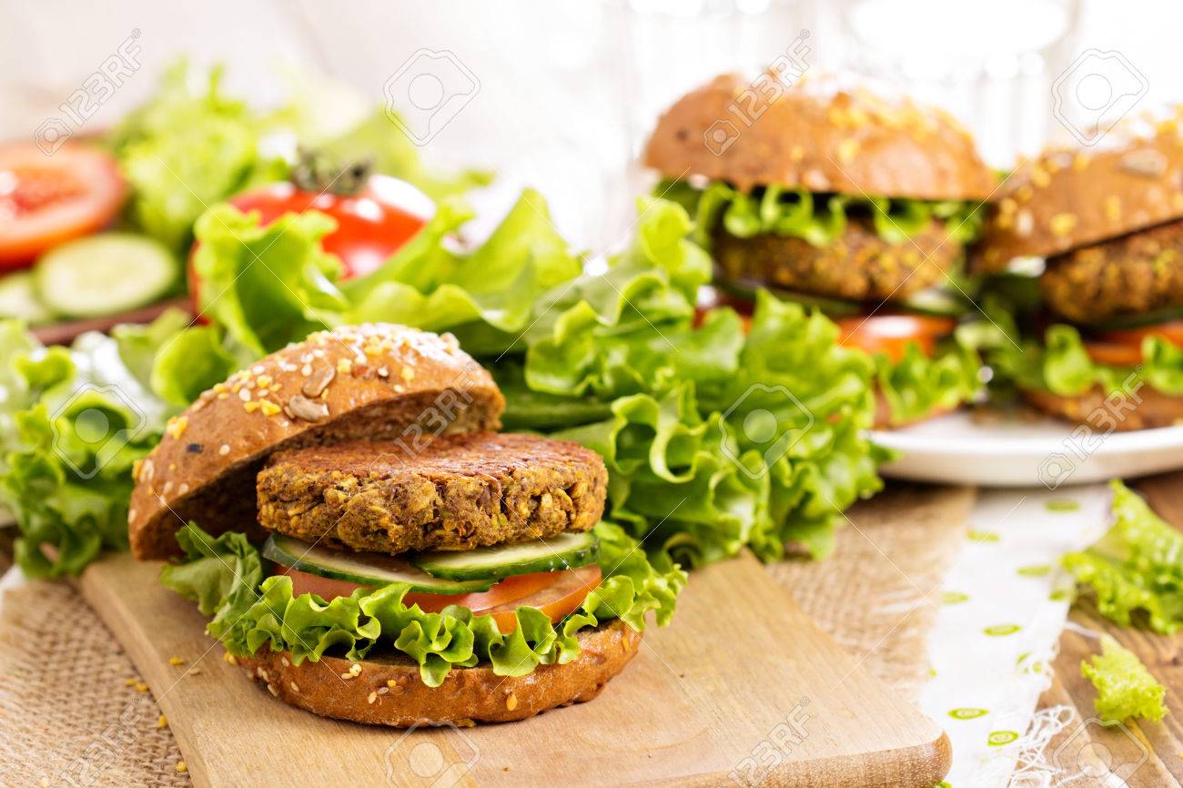 Vegan burgers with lentils and pistashios stacked on a cutting board - 42029074 Vegan burgers with lentils and pistashios stacked on a cutting board - 42029074