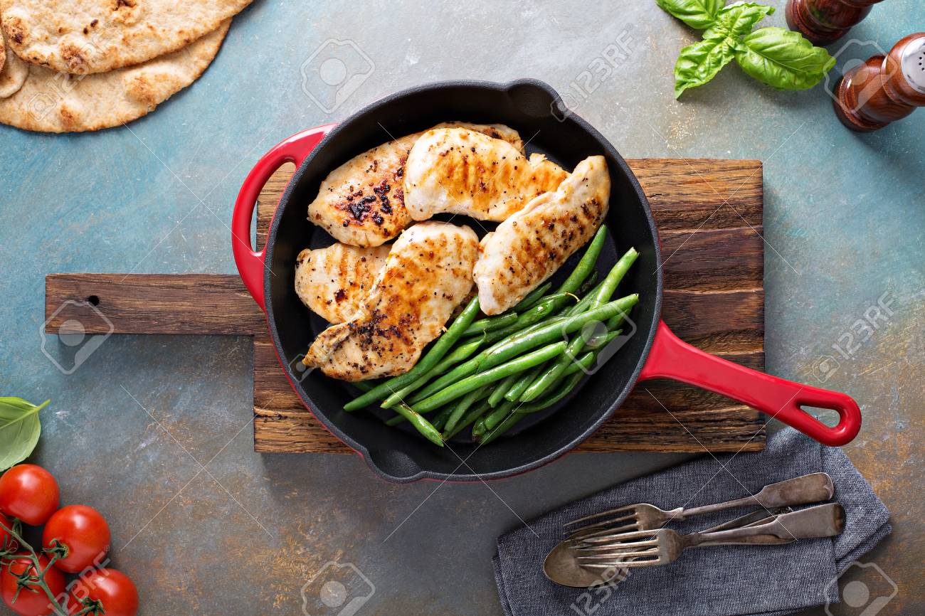 Grilled chicken with green beans in a cast iron skillet - 94417798 Grilled chicken with green beans in a cast iron skillet - 94417798