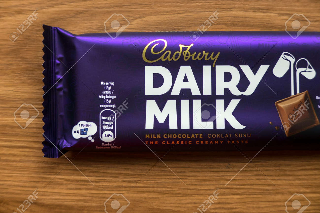 KEDAH,MALAYSIA - MARCH 6TH,2021 : Cadbury Dairy Milk Chocolate Bar On Wooden Background. Cadbury Dairy Milk Is A Brand Of Milk Chocolate Manufactured By Cadbury. Stock Photo, Picture And Royalty Free Image. KEDAH,MALAYSIA - MARCH 6TH,2021 : Cadbury Dairy Milk Chocolate Bar On Wooden Background. Cadbury Dairy Milk Is A Brand Of Milk Chocolate Manufactured By Cadbury. Stock Photo, Picture And Royalty Free Image.