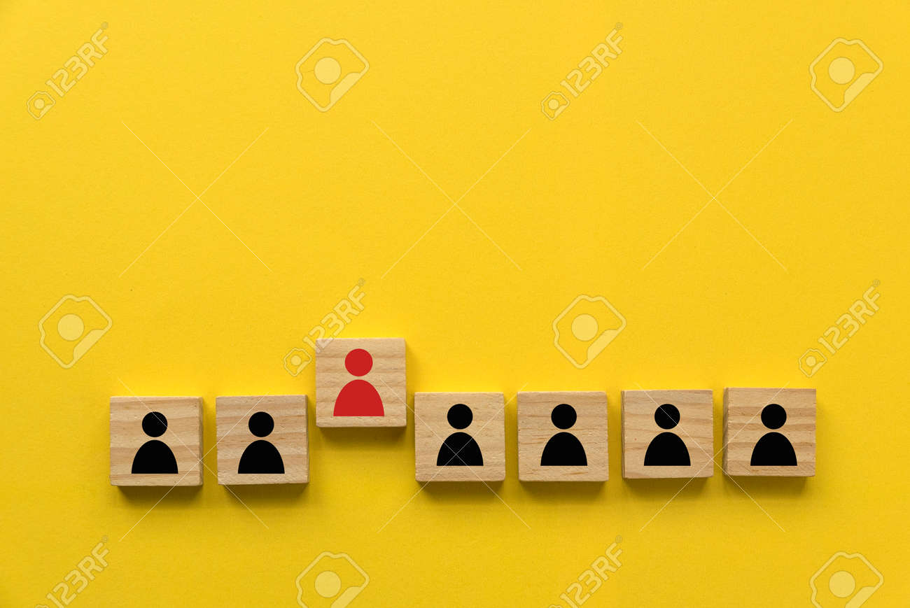 A row of wooden cube with people icon with one red people standing out from other. - 169597251 A row of wooden cube with people icon with one red people standing out from other. - 169597251