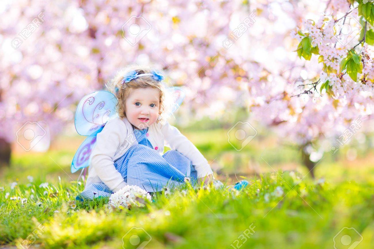 Adorable Toddler Girl With Curly Hair And Flower Crown Wearing
