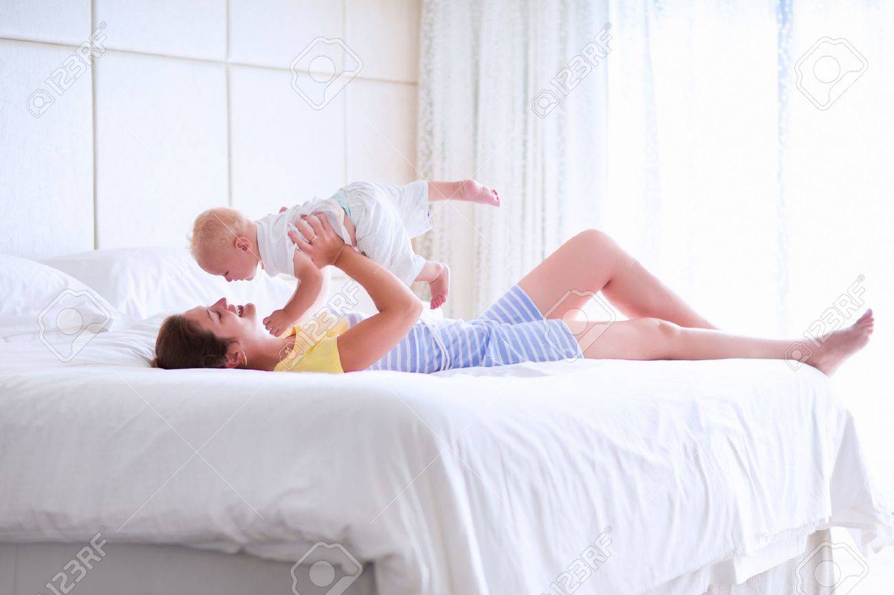 Mother And Baby In Bed Young Mom Playing With Her Newborn Son Stock Photo Picture And Royalty Free Image Image Mother And Baby In Bed Young Mom Playing With Her Newborn Son Stock Photo Picture And Royalty Free Image Image