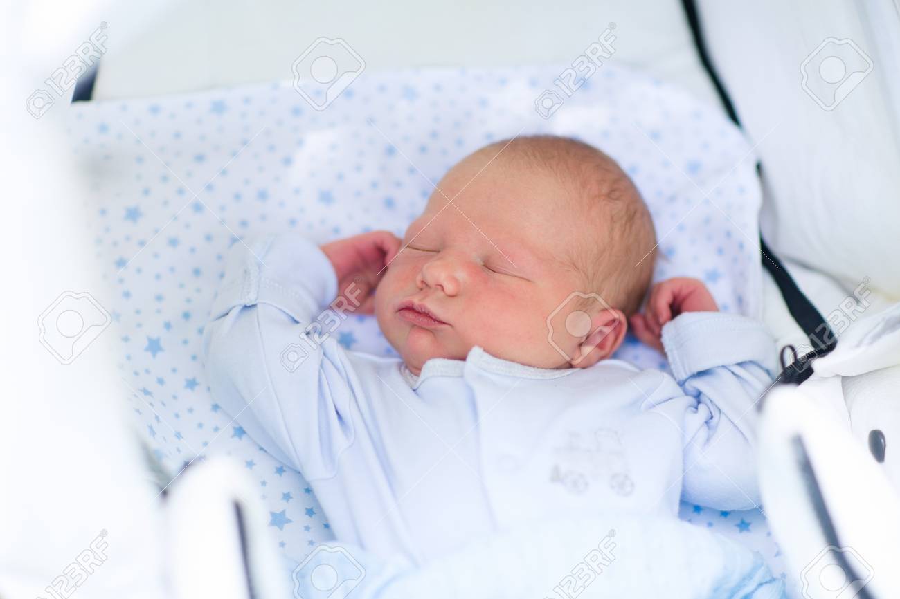 Bebé recién nacido durmiendo en cochecito blanco en una caminata en el parque de verano. Nueva niño nacido siesta al aire libre en un día soleado Bebé recién nacido durmiendo en cochecito blanco en una caminata en el parque de verano. Nueva niño nacido siesta al aire libre en un día soleado