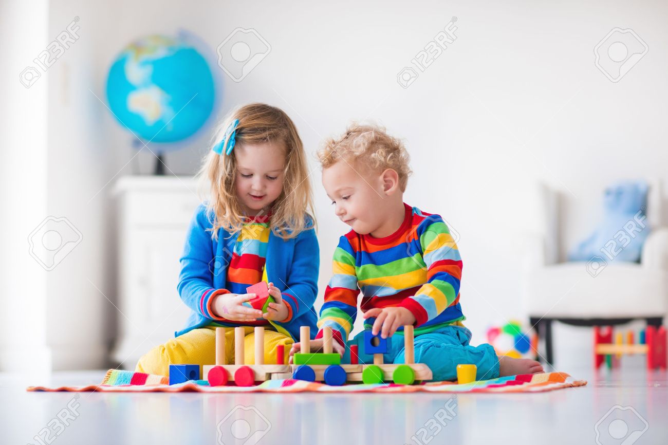 children playing with wooden train toddler kid and baby play with children playing