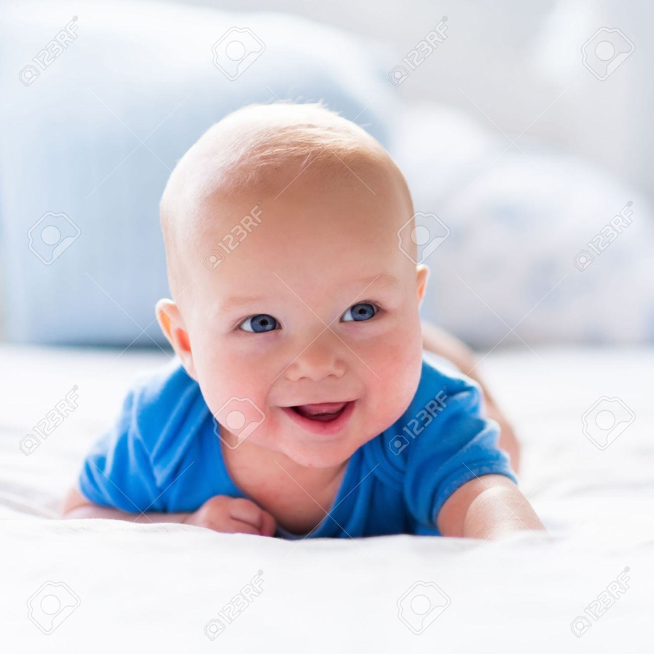 Adorable baby boy in white sunny bedroom. Newborn child relaxing in bed. Nursery for young children. Textile and bedding for kids. Family morning at home. New born kid during tummy time with toy bear. - 50840314 Adorable baby boy in white sunny bedroom. Newborn child relaxing in bed. Nursery for young children. Textile and bedding for kids. Family morning at home. New born kid during tummy time with toy bear. - 50840314