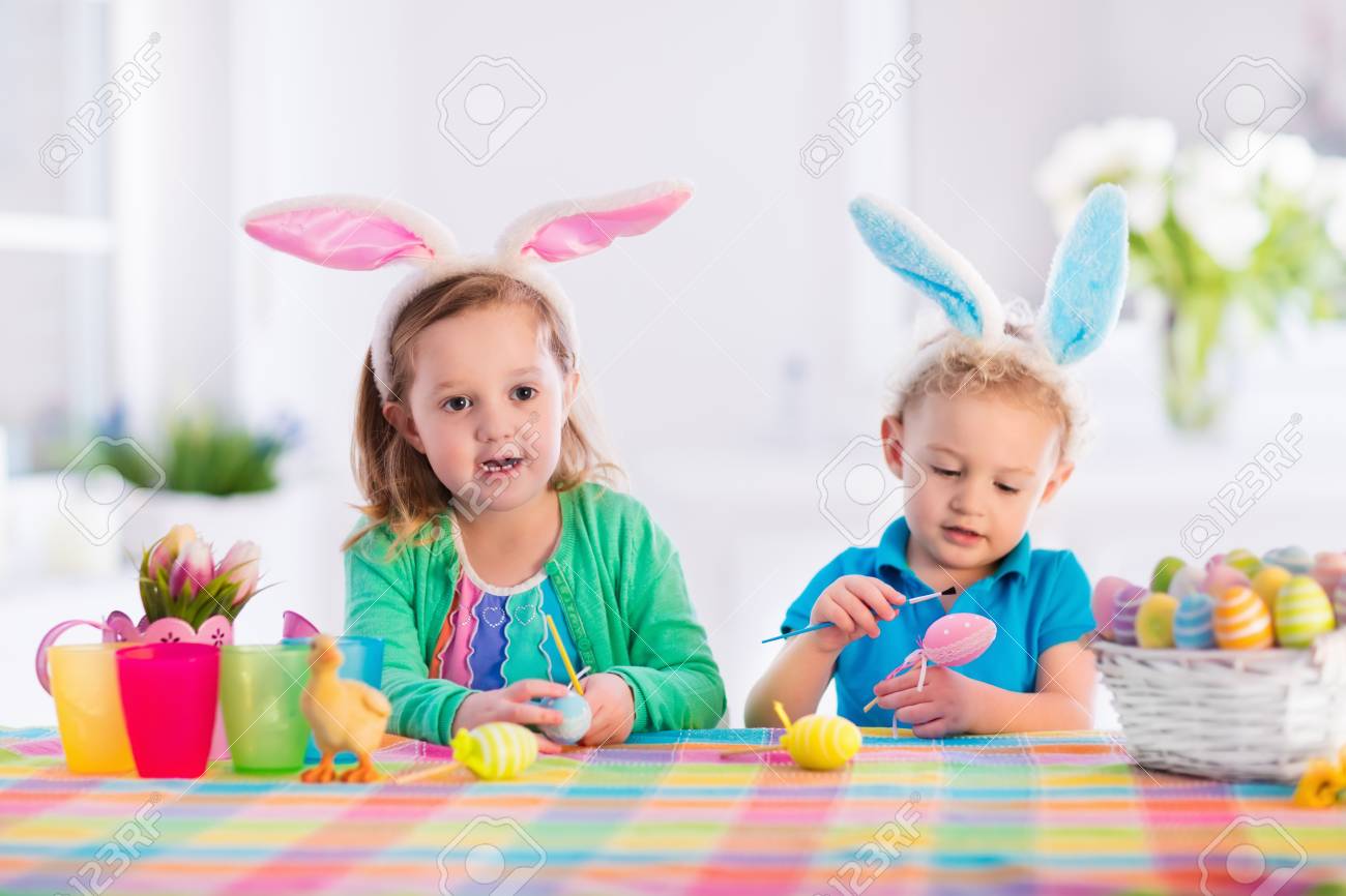 Kids painting colorful eggs children paint and decorate easter egg toddler kid and preschooler