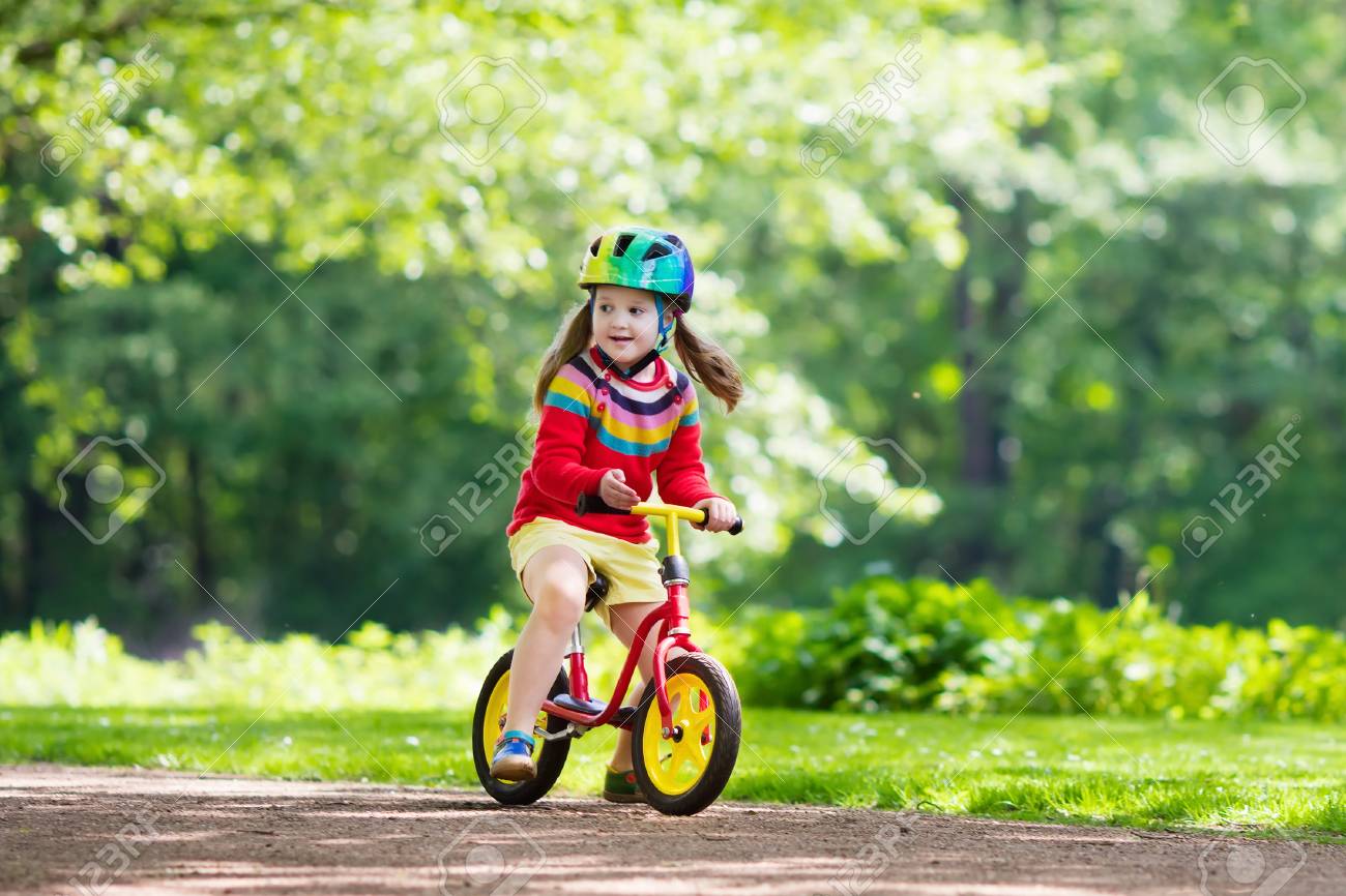 kid riding balance bike