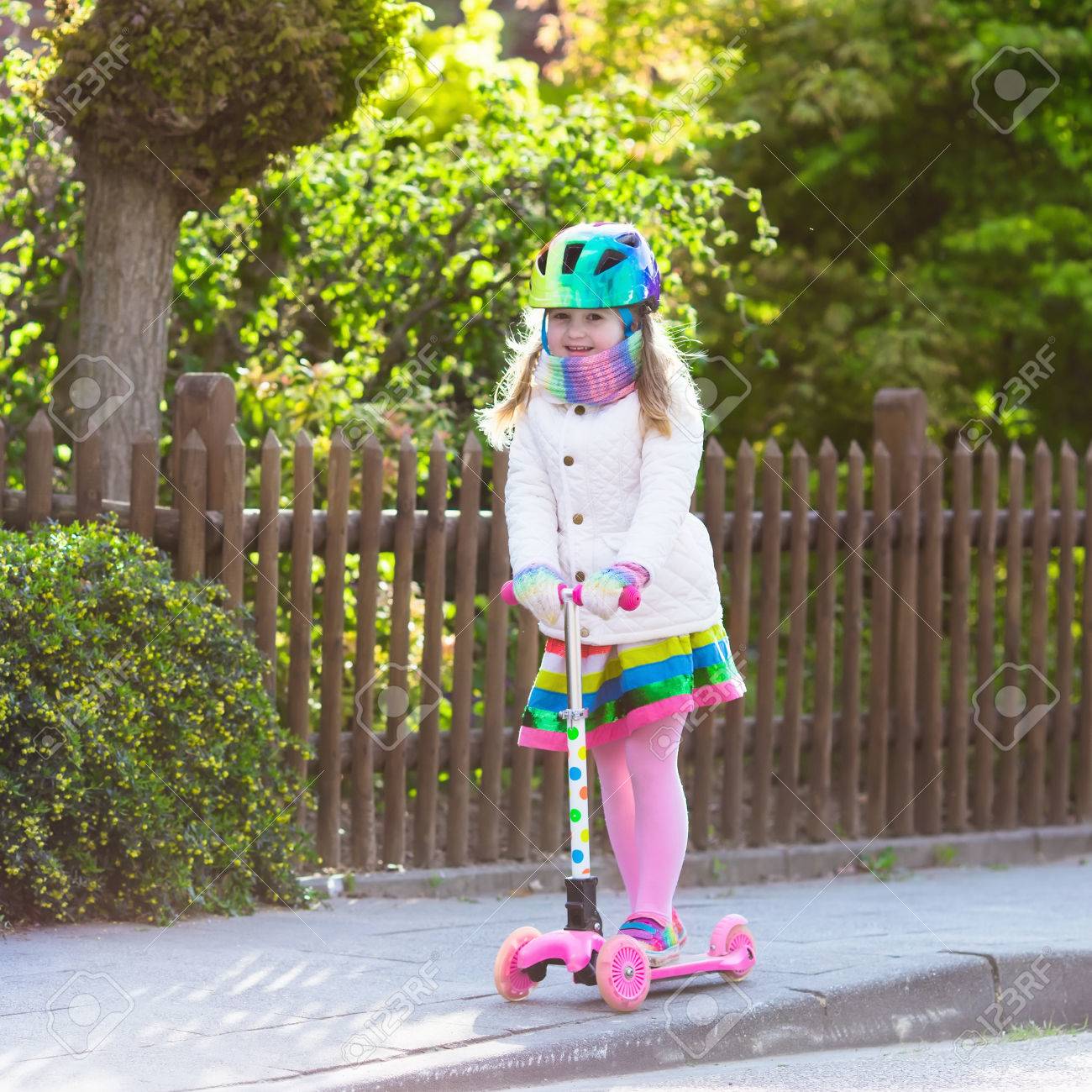 little girl riding scooter