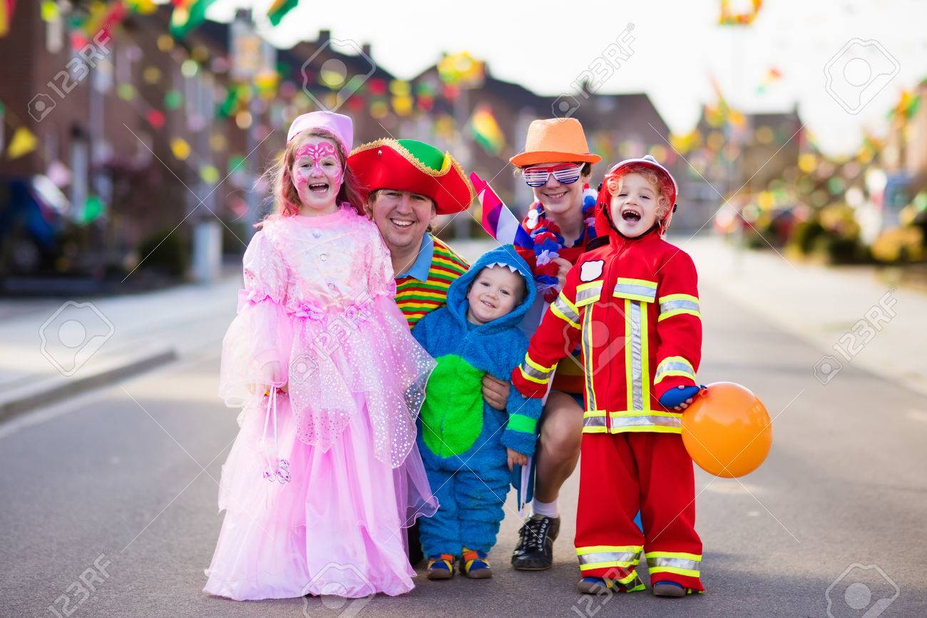 Kids and parents on Halloween trick or treat. Family in Halloween costumes with candy bags walking in decorated street trick or treating. Baby and preschooler celebrating carnival. Child costume. - 85529817 Kids and parents on Halloween trick or treat. Family in Halloween costumes with candy bags walking in decorated street trick or treating. Baby and preschooler celebrating carnival. Child costume. - 85529817