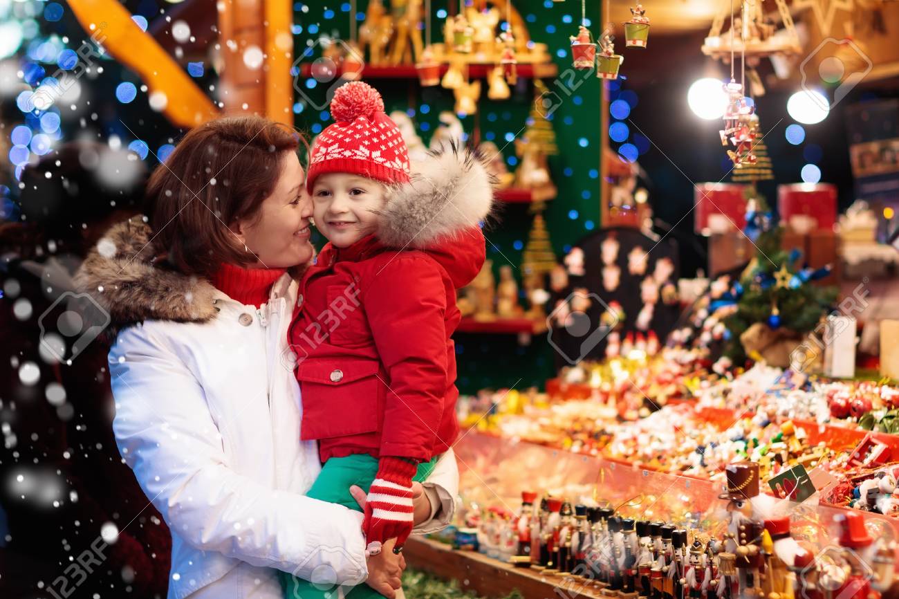 Traditional German Christmas Tree Ornaments Part - 16: Mother And Child In Warm Hat Watching Handmade Glass Christmas Tree Ornaments At Traditional German Xmas