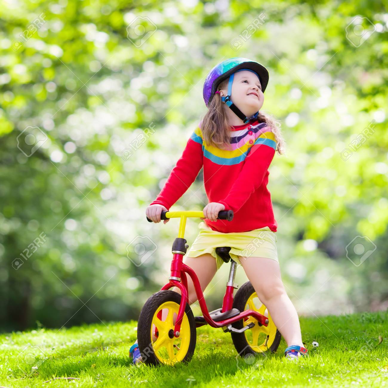 kid riding balance bike