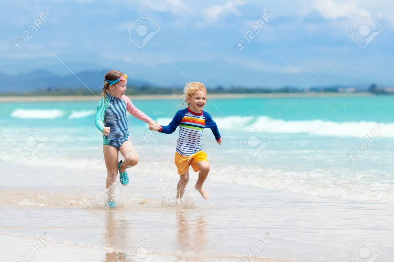 97380282-child-playing-on-tropical-beach-little-girl-digging-sand-at-sea-shore-family-summer-vacation-kids-pl.jpg