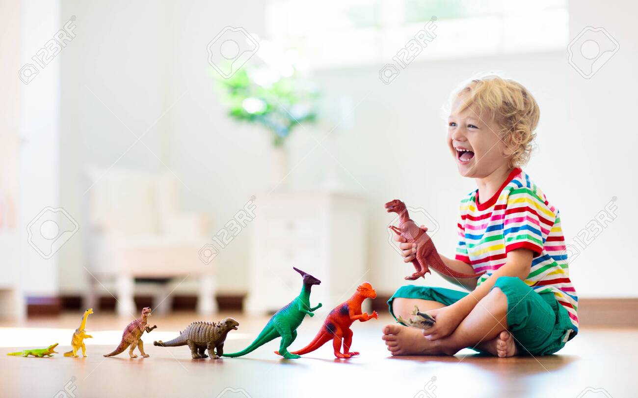 kids playing with dinosaur toys